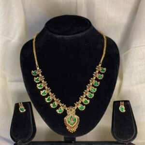 Elegant mango design necklace set with green stones. Perfect for weddings and festive wear. Lightweight, stylish, and premium finish.